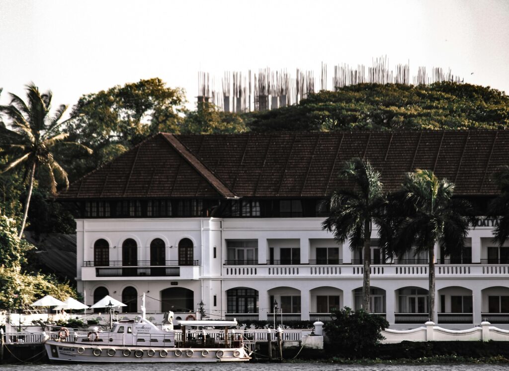 Elegant hotel exterior with palm trees and water, perfect for travel inspiration.