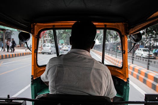 Experience the vibrant city life from the backseat of an auto rickshaw, capturing the essence of urban transport.